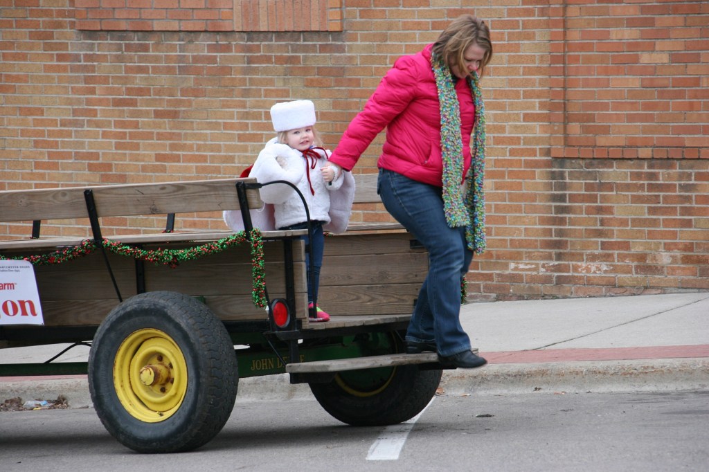 After a ride through downtown Faribault in a horse-drawn wagon, Lyla and her mom exited by the KC Hall.