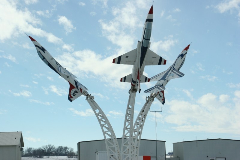 Blue skies accentuate fighter jets at Owatonna Degner Regional Airport along the Interstate.