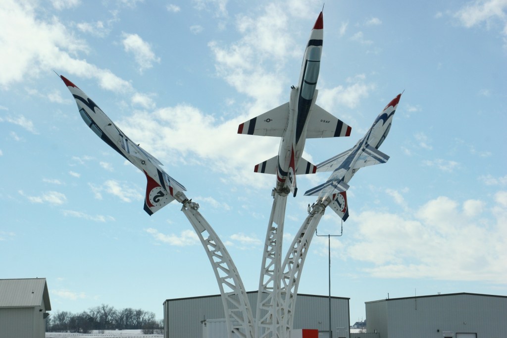 Blue skies accentuate fighter jets at Owatonna Degner Regional Airport along the Interstate.