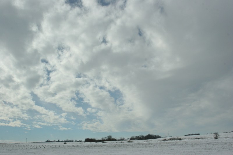 To the west of Interstate 35, clouds billow above snow-washed fields.