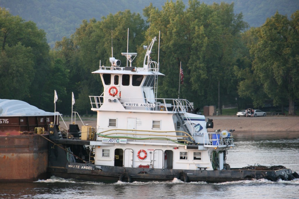The White Angel tugs a barge.