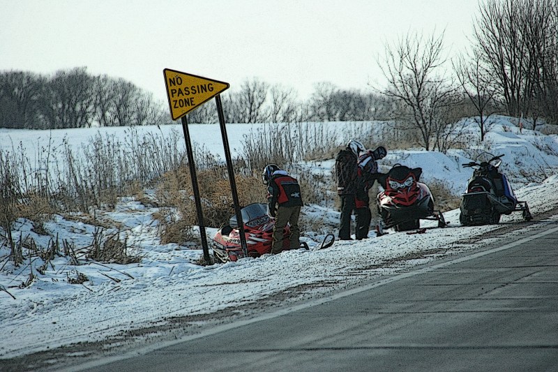 With windchills in the minus 20-degree range, Saturday afternoon, these snowmobilers dealt with machine break-down issues in the countryside.