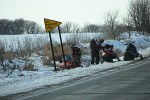 Winter scene, 10 snowmobilers alongside&nbsp;road