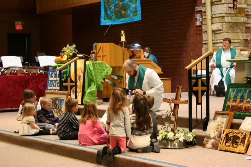 The Rev. Paul Rieger uses a book to showcase Creation during the children's object lesson.