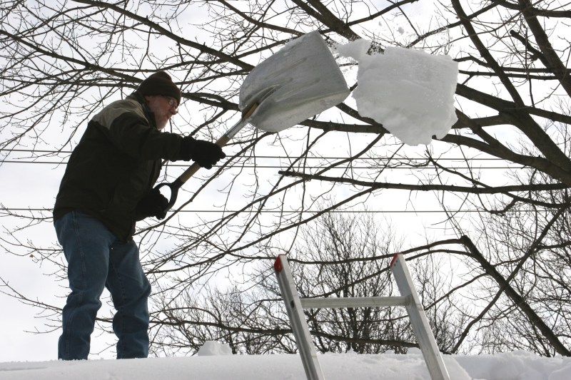 Shoveling snow off roof, 67