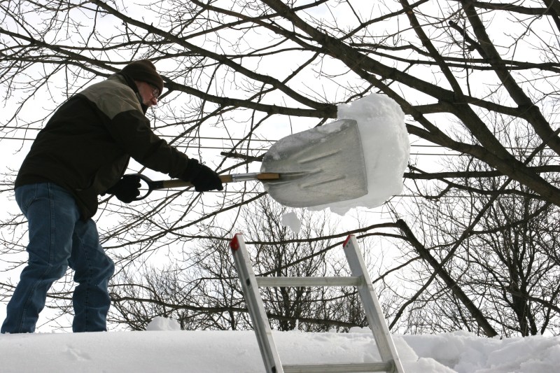Shoveling snow off roof, 68
