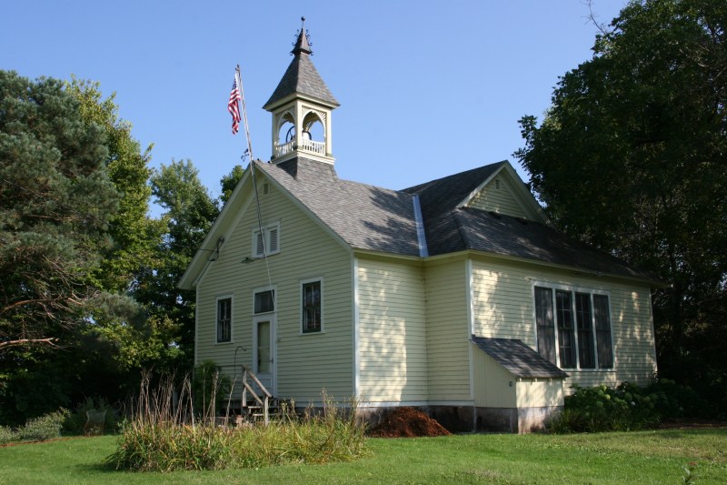 The old schoolhouse is painted a lovely buttery yellow.