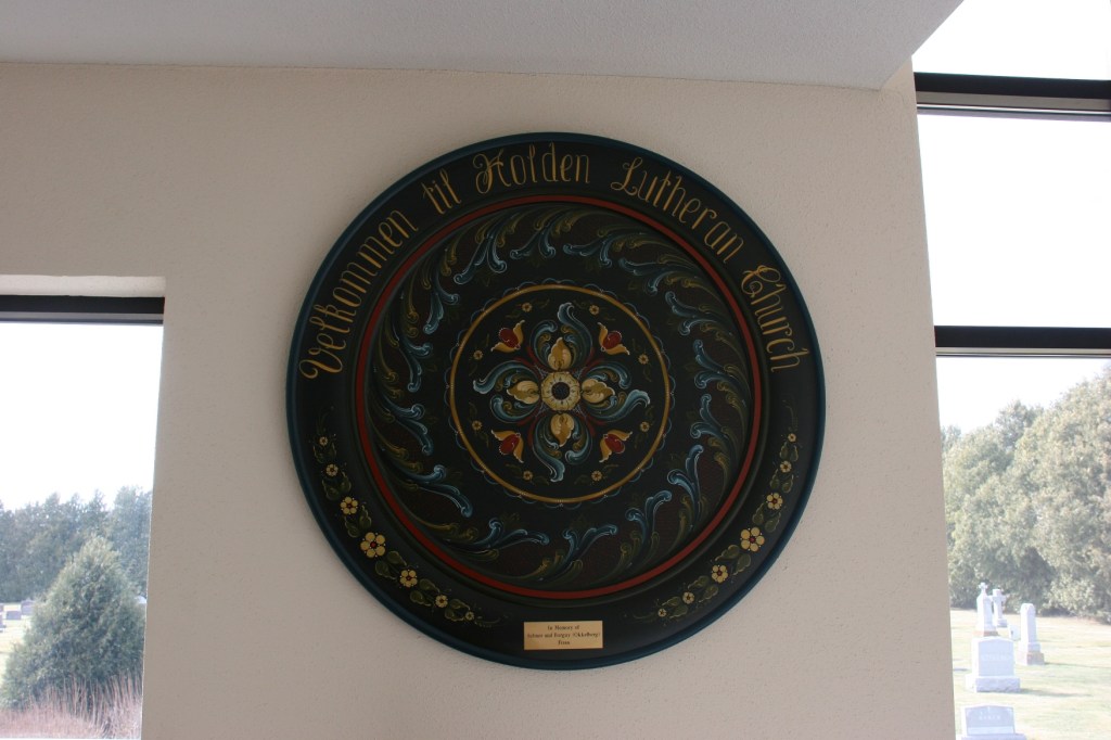 Holden's Norwegian heritage is reflected in this rosemaling art hung in the narthex.