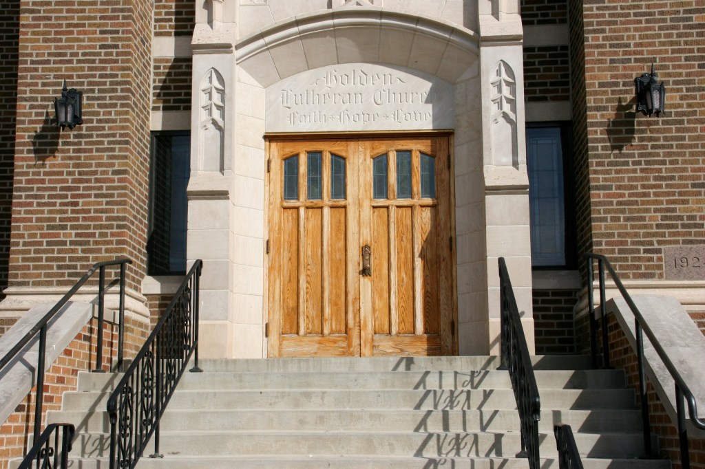 The front entry to Holden Lutheran is stunning. Faith, hope and love are chiseled above the oak doors.