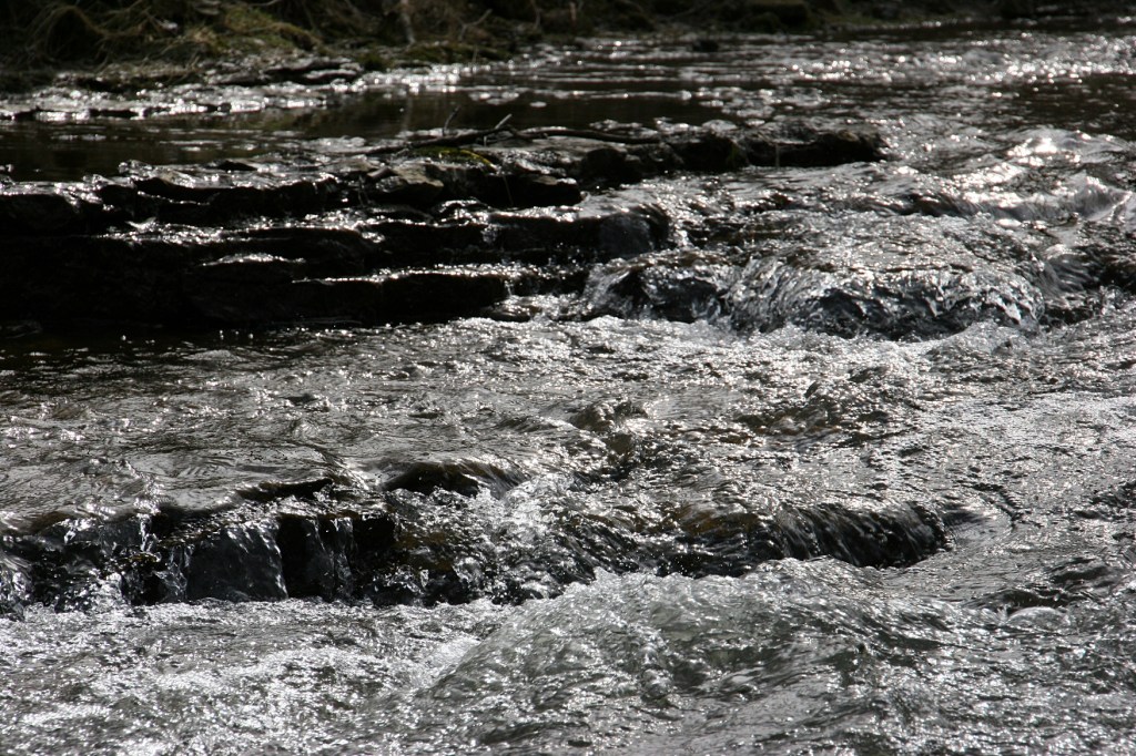 Water rushes over limestone ledges.