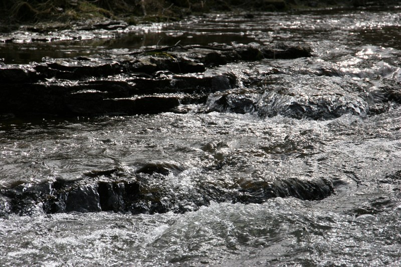Water rushes over limestone ledges.