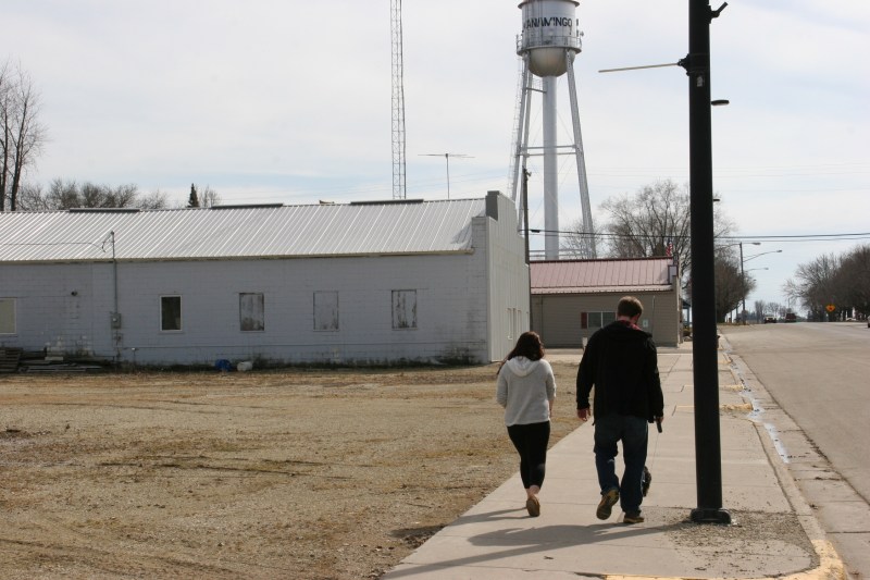 Walking the puppy downtown. Wanamingo still has an old style water tower.