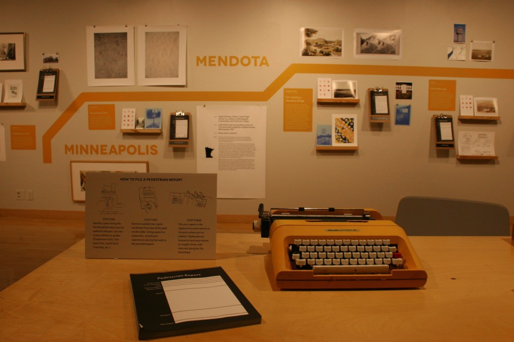 At one of two tables, exhibit visitors can sit and file a Pedestrian Report...