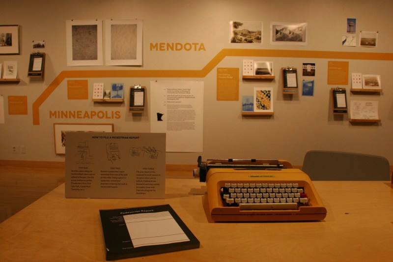 At one of two tables, exhibit visitors can sit and file a Pedestrian Report...