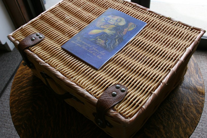 A basket holds church bulletins and other worship essentials.