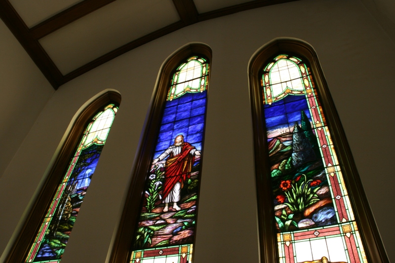 This trio of stained glass windows rises above the altar.