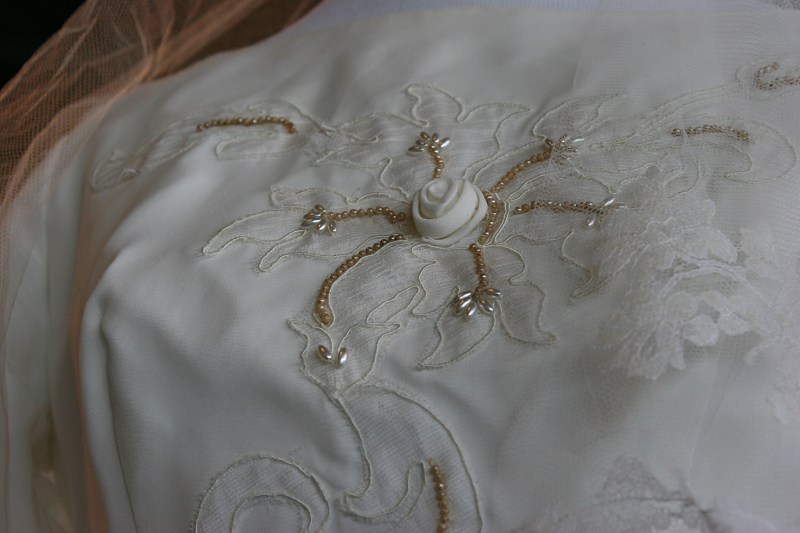 Lovely fabric rosettes adorn a 1964 bridal gown.