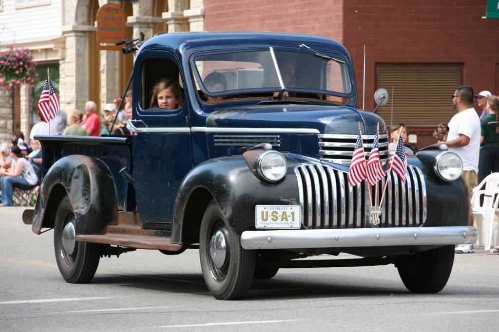 Parade, 45 old blue pick-up truck