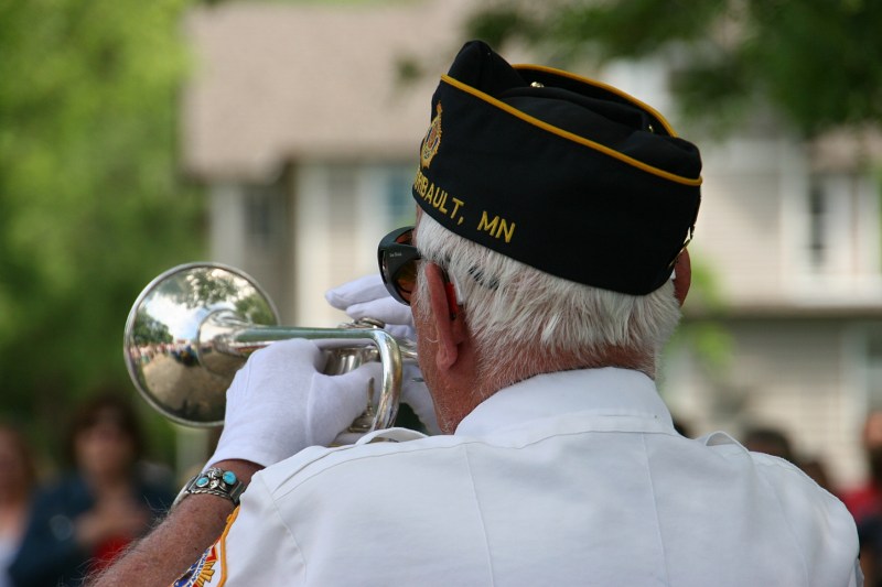A veteran plays taps at the conclusion of the program.