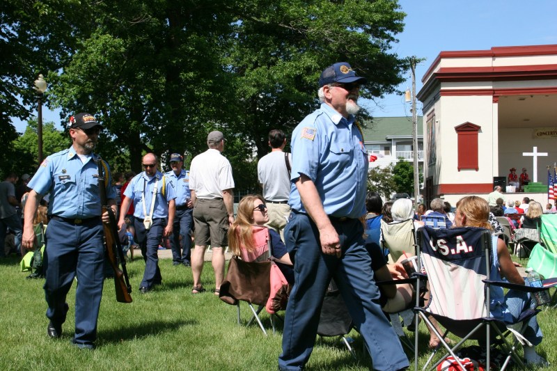 Veterans walk through the crowd after advancing the colors.