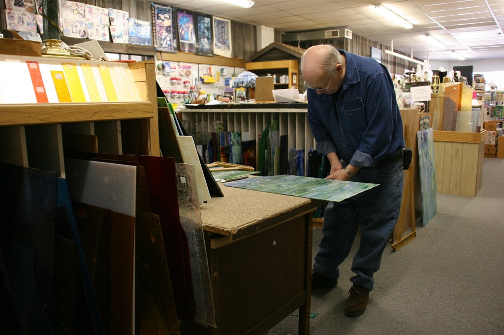 Mike cuts salvaged stained glass to sell.