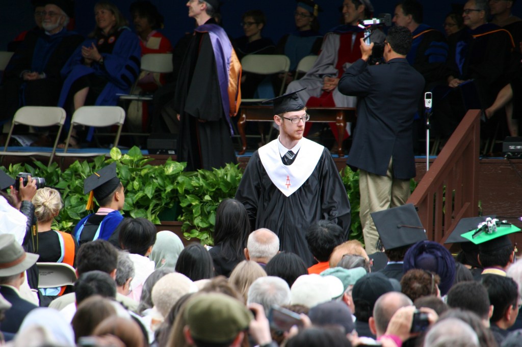 Caleb returns to his seat after graduating from Tufts University School of Engineering with a bachelor of science degree in computer science.