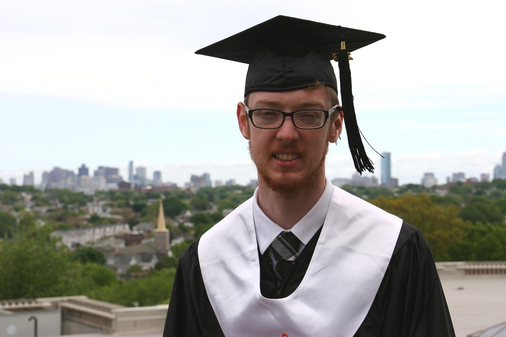 Posing afterward atop the roof of the Tufts library with the Boston skyline some 10 miles in the distance.