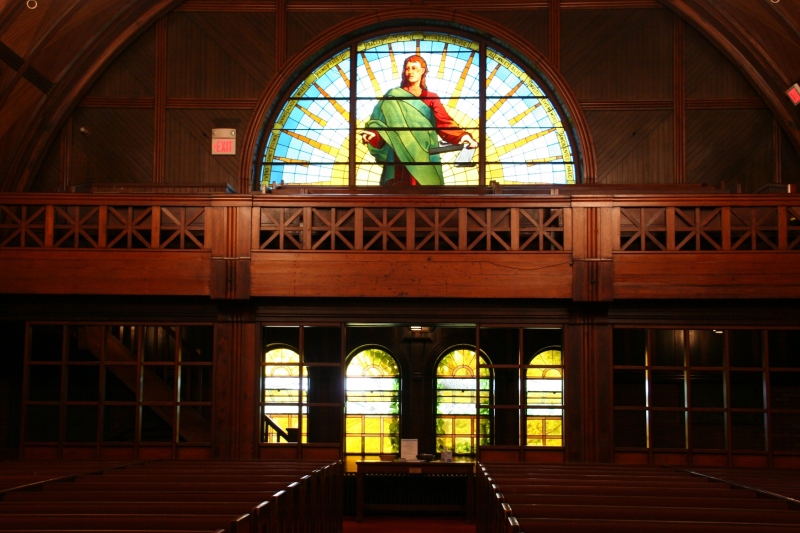 Beautiful stained glass windows and dark wood dominate Goddard Chapel.