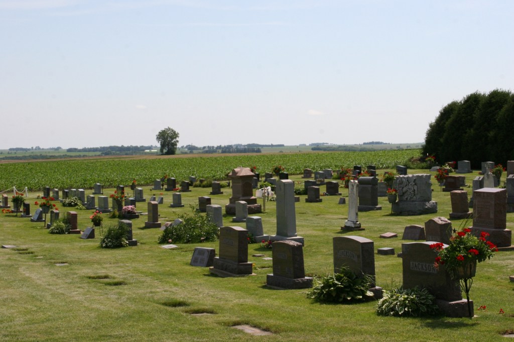 A section of the cemetery that lies next to Emmanuel Lutheran Church and next to a field.