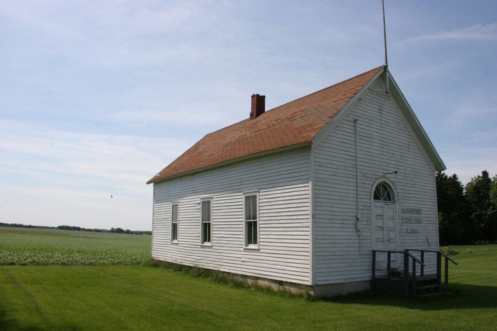 The old Wanamingo Township Hall, built in 1862, stands next to the church.