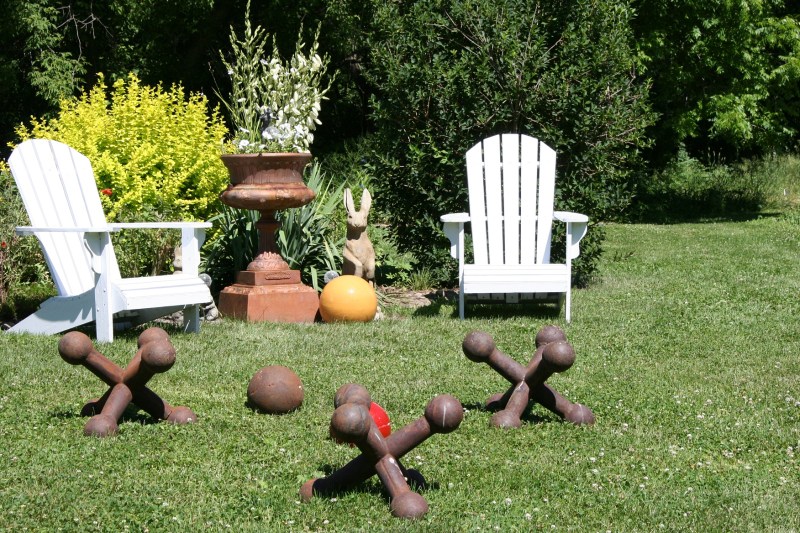 The oversized jacks and balls draw the eye to a place to kick back on Adrionack chairs.