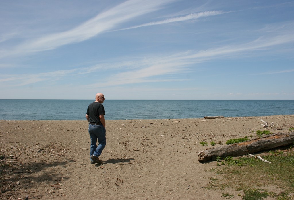 Randy walking along the shore of Lake Erie on a recent road trip to the East Coast.