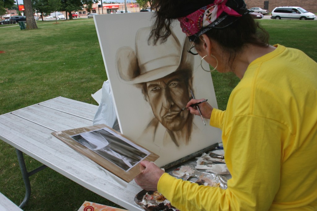 Using a photo as her guide, Dana works on her Dylan portrait.