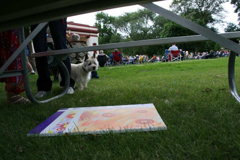 One artist slid her art under a picnic table to protect it from the rain.