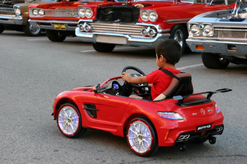 Boy in his Mercedes, 74 next to other cars