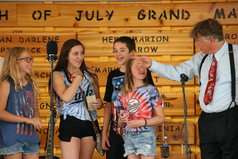 The winners of the medallion hunt are introduced and presented with a $100 check.