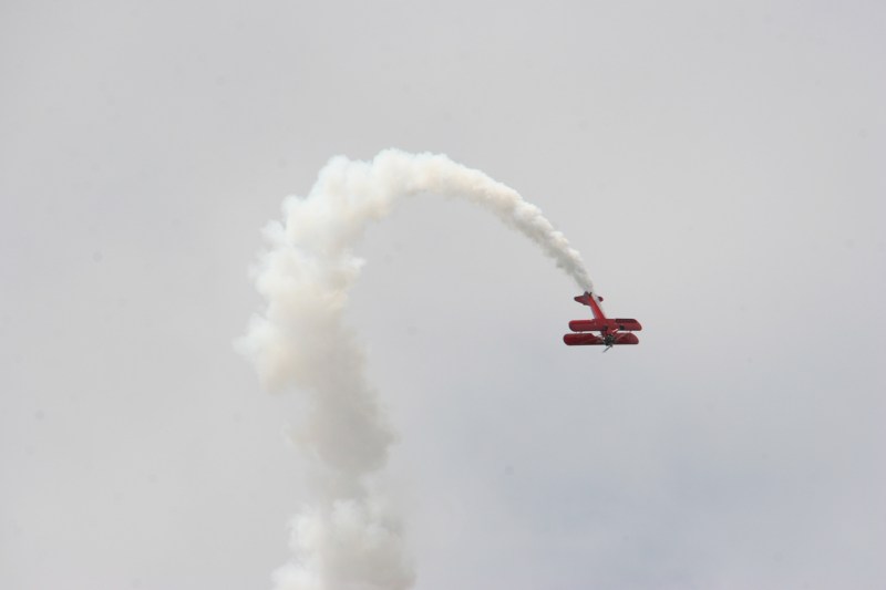 A biplane buzzes the festival grounds mid-afternoon.
