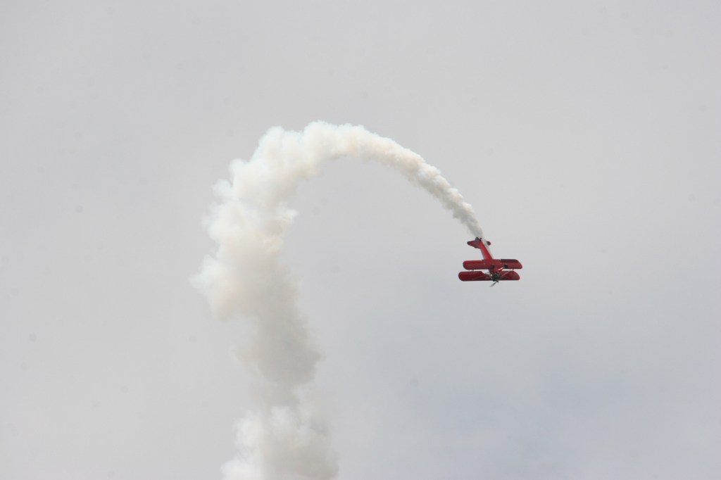 A biplane buzzes the festival grounds mid-afternoon.