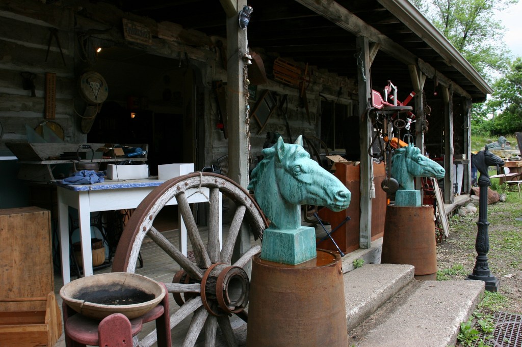 A scene outside a building filled with antiques and collectibles.