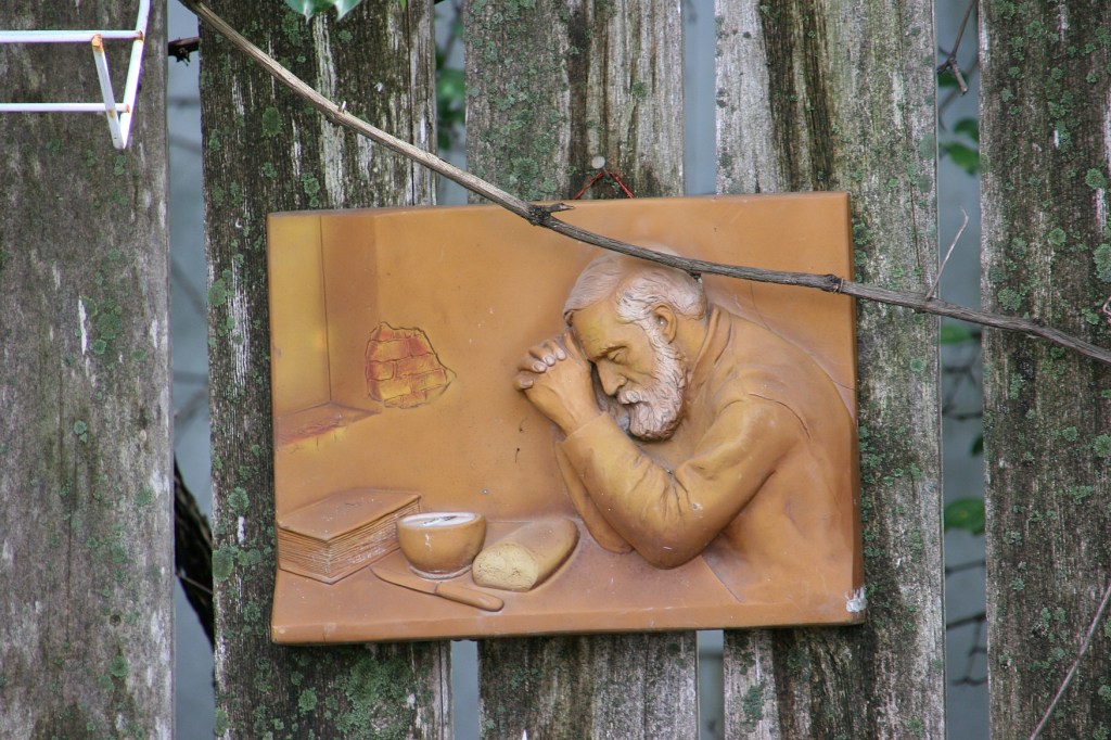 Art on the fence lining the driveway.