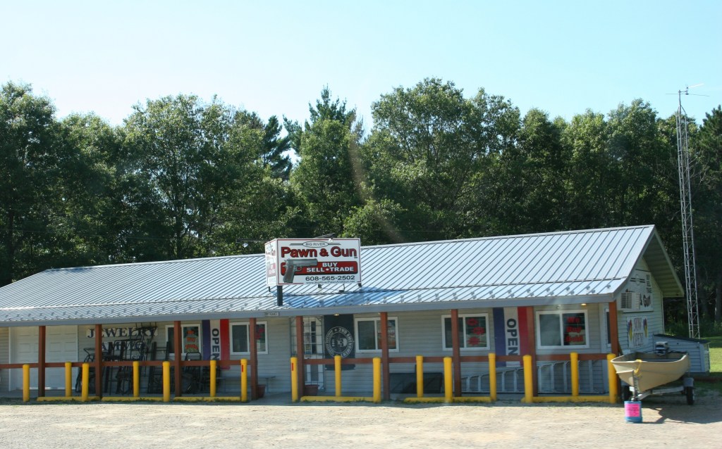 A pawn shop, somewhere along State Highway 21 between Omro and Tomah advertises guns.