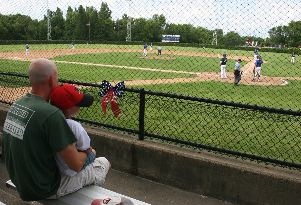Father and son bond at the ball game.
