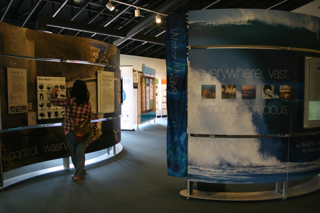 Entering the "Water/Ways" exhibit, a collection of informational panels.
