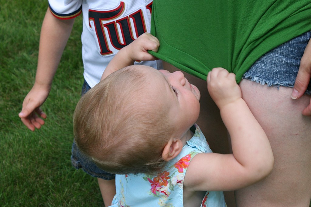 Sierra tugs at her mommy's shirt.