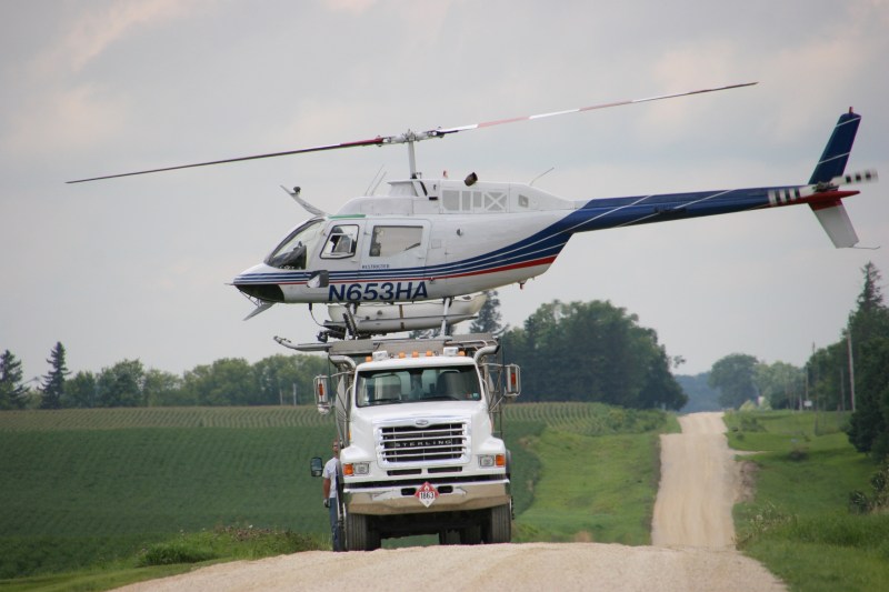 Helicopter spraying, 124 atop mixing truck