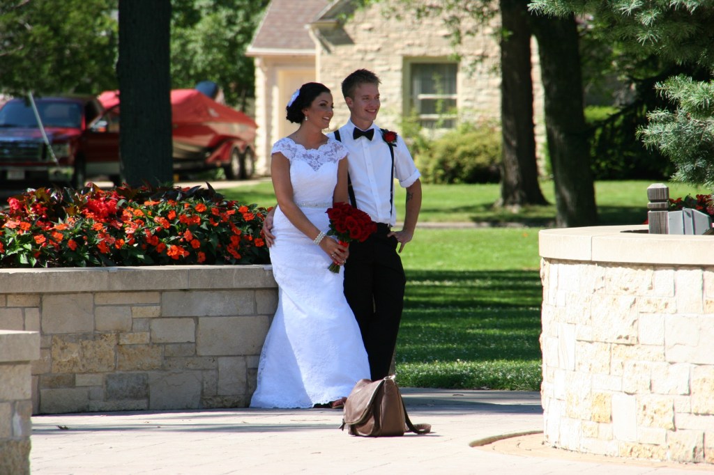 "Ring Dance" seems fitting for a wedding photo shoot. Here the couple poses near a massive round flowerbed in City Park.