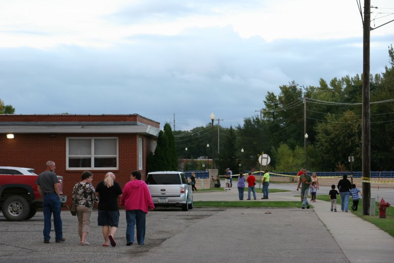 Locals headed across the Faribault Woolen Mill parking lot toward the rising Cannon River.
