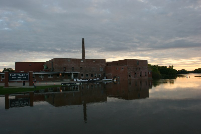 The water has risen so high that the Cannon River dam is no longer visible next to the Faribault Woolen Mill.