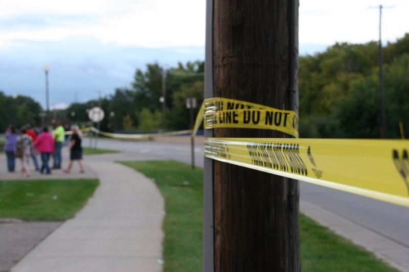Police tape runs along the sidewalk on Second Avenue between the Faribault Woolen Mill and Faribault Foods.