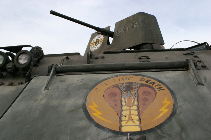 A close-up of a tank on display reveals the harsh words of war.